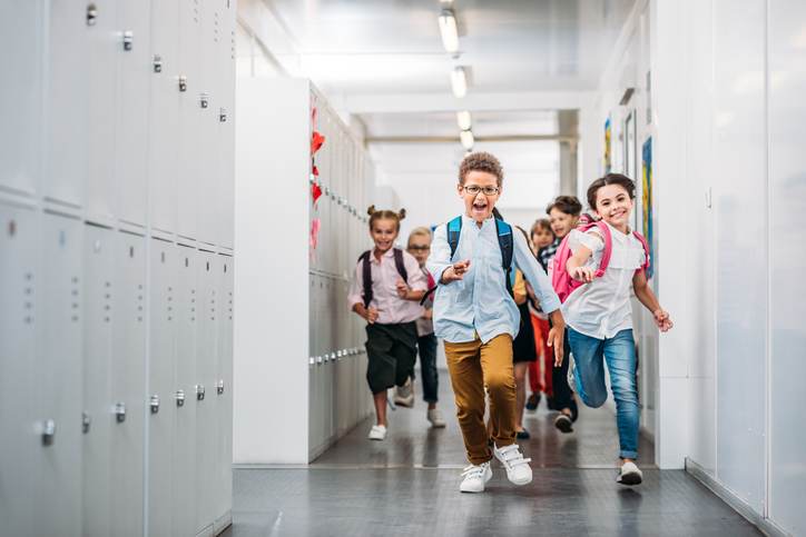 pupils running through school corridor