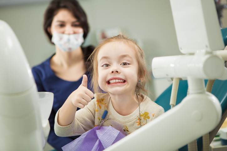 Cheerful kid with broad smile after teeth polishing procedure