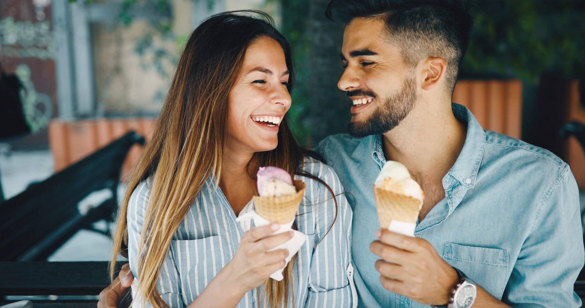 Happy couple having date and eating ice cream