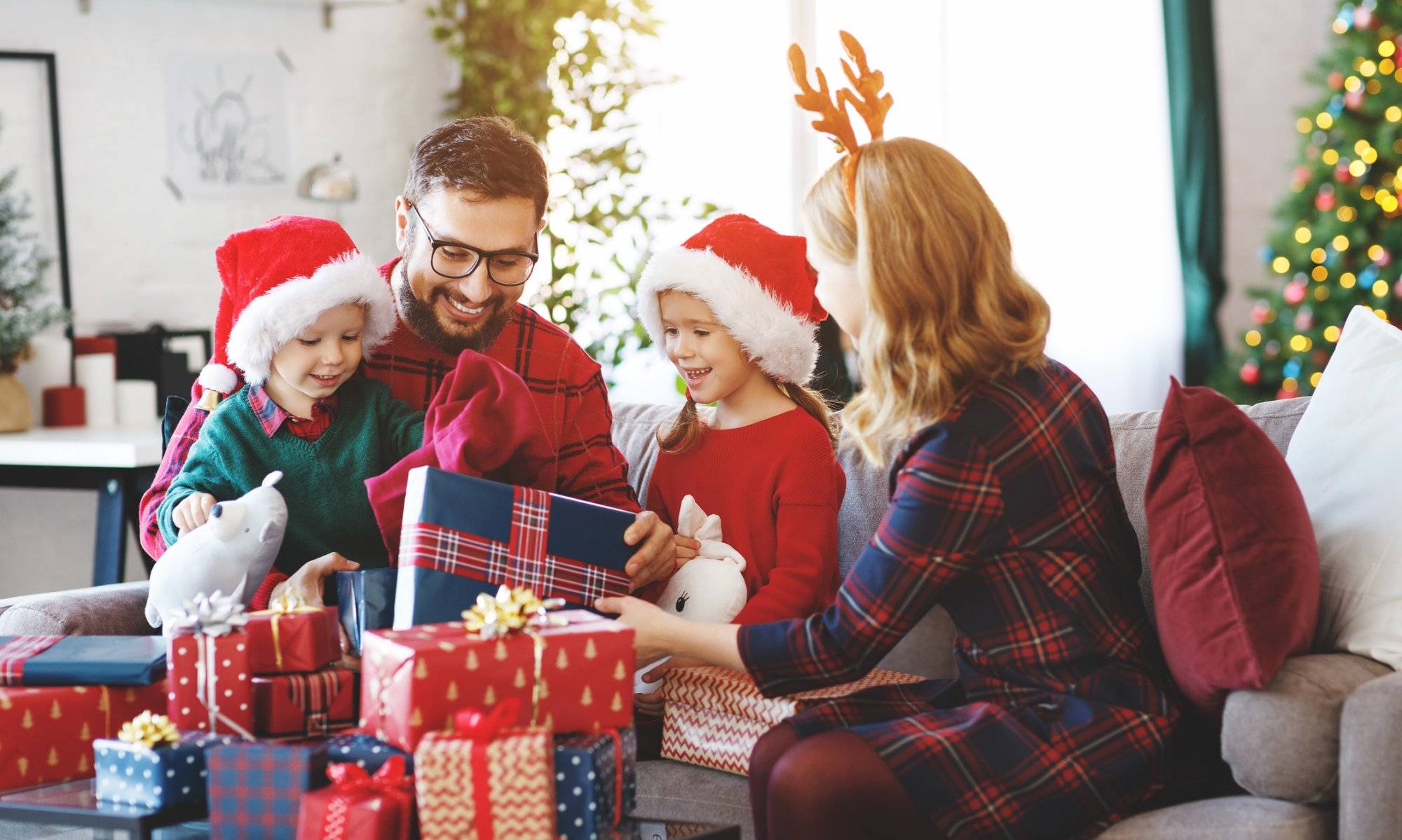 happy family open presents on Christmas morning Discover the Ultimate Christmas Gift Guide in Flower Mound
